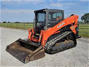 Skid steer cleaning up debris and material on a job site